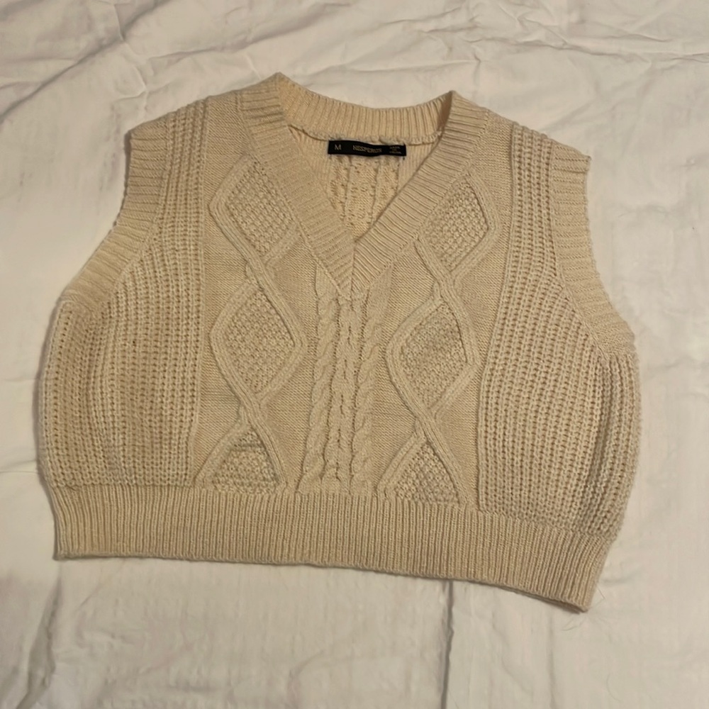 Soft knit, sleeveless sweater.